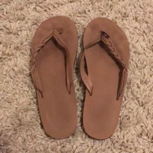 Rainbow braided flip flops.